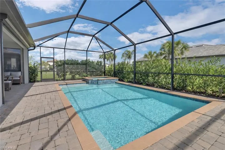 Relaxing pool / spa with a lanai, a sunroom, and a patio area
