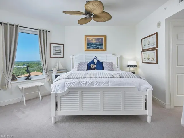 Carpeted bedroom with ceiling fan