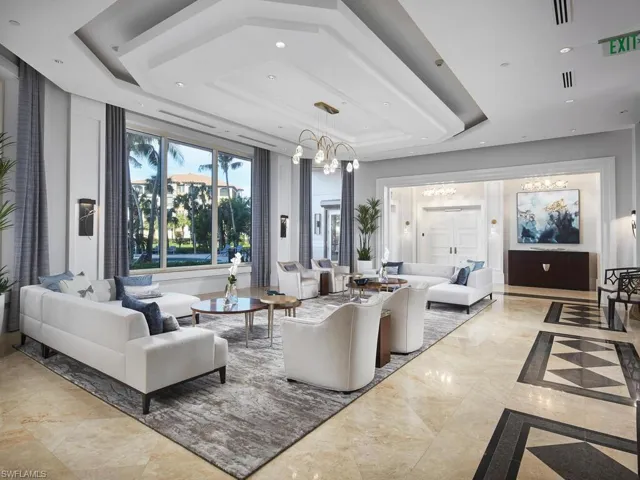 Living room with a notable chandelier and a tray ceiling