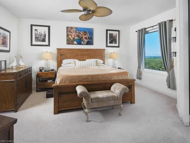 Carpeted bedroom with ceiling fan