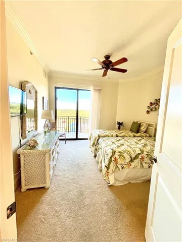 Bedroom featuring access to exterior, carpet flooring, ceiling fan, and ornamental molding
