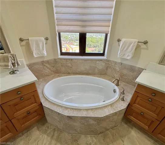 Master Bathroom with vanity and tiled tub