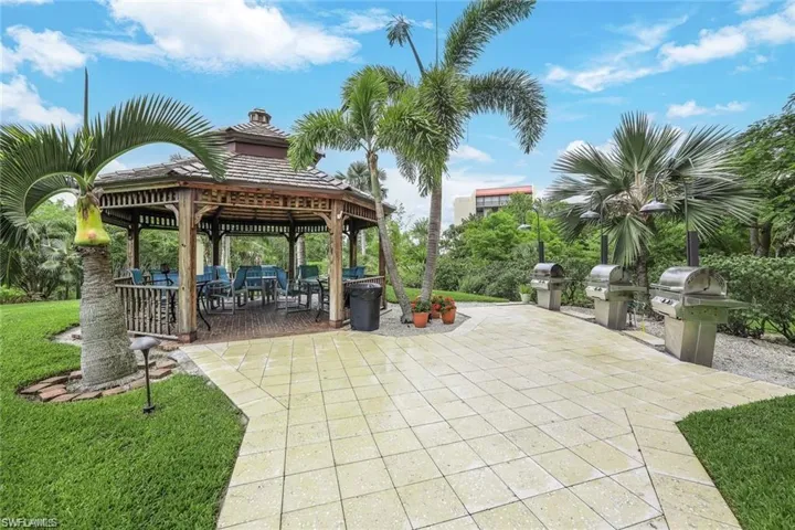 View of patio with a gazebo, an outdoor kitchen, and a grills
