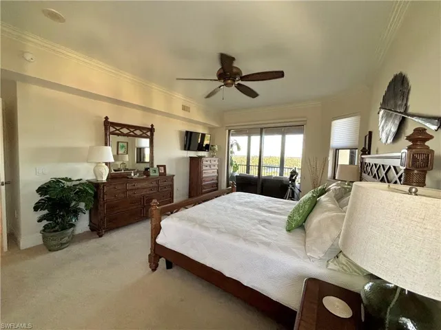 Master Bedroom featuring ceiling fan, access to exterior, ornamental molding, and light carpet