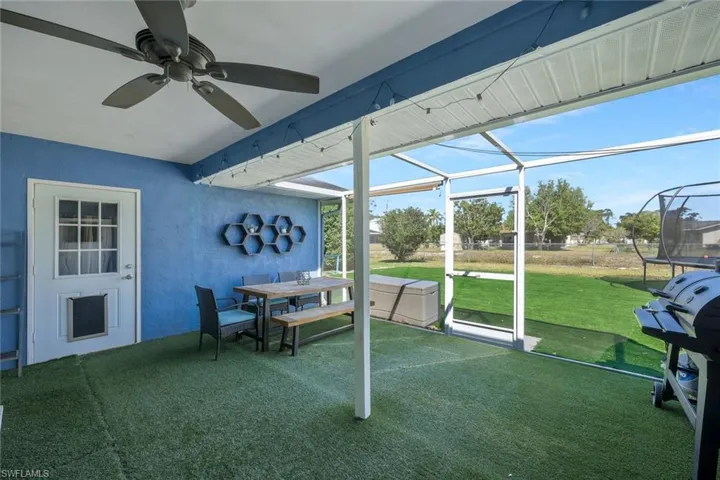 Sunroom / solarium with outdoor dining area, plenty of natural light, and ceiling fan