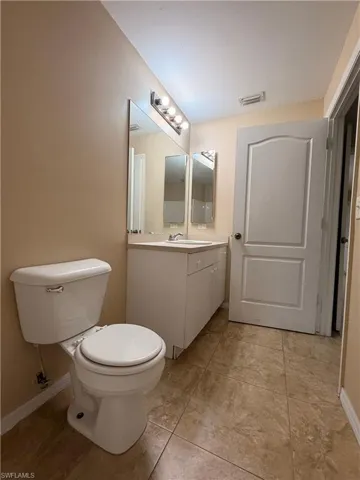Half bathroom with vanity and toilet