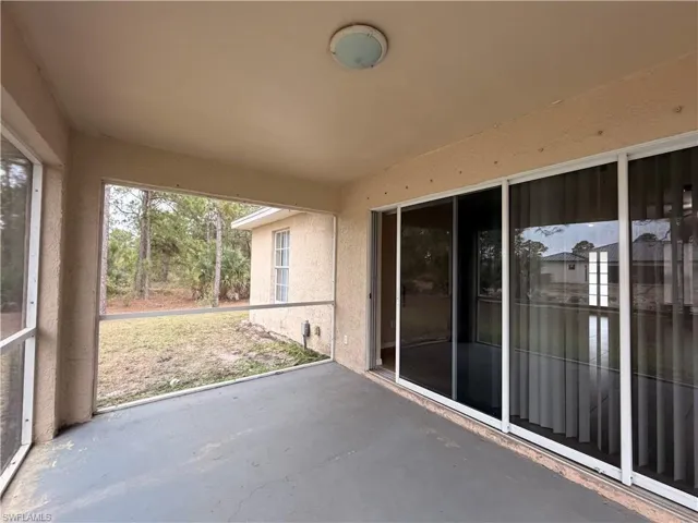 View of patio featuring a sunroom