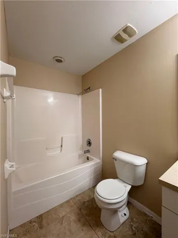 Bathroom with vanity and shower / tub combination
