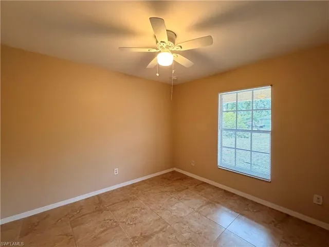 Unfurnished bedroom with a ceiling fan and a closet