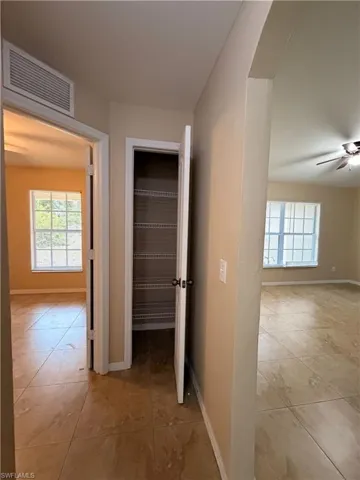 Corridor with light tile patterned floors