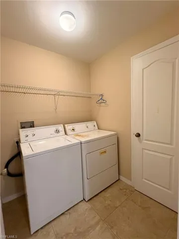 Laundry area featuring washer and clothes dryer and baseboards