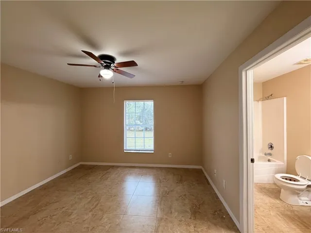 Unfurnished room featuring ceiling fan and light tile patterned flooring