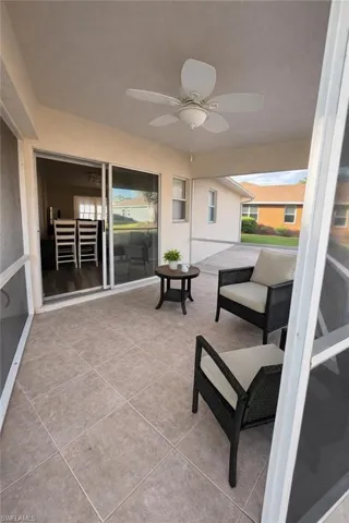 Sunroom with ceiling fan, a patio, and healthy amount of natural light
