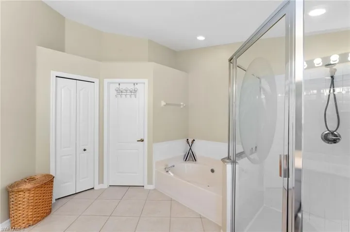Bathroom featuring separate shower and tub and tile patterned floors