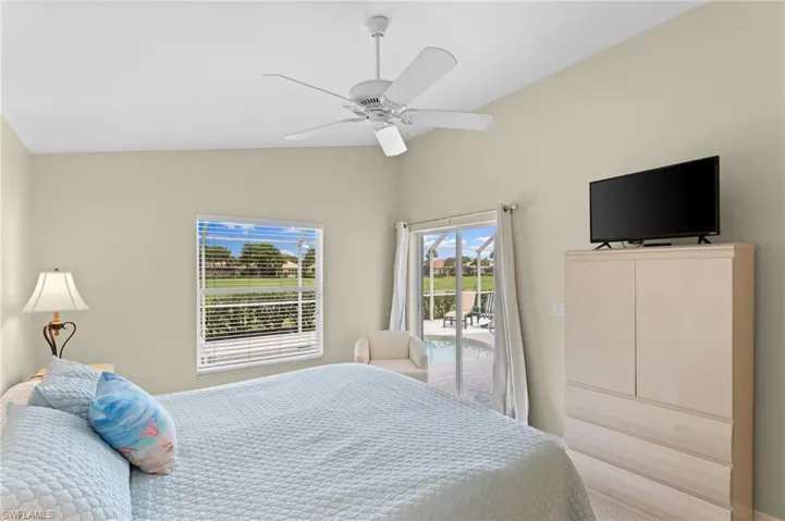 Bedroom with access to outside, ceiling fan, and lofted ceiling