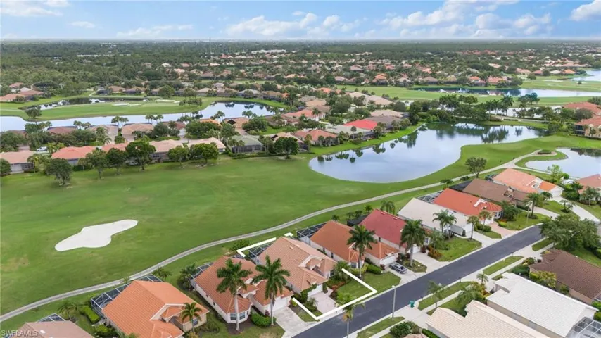 Birds eye view of property with a water view
