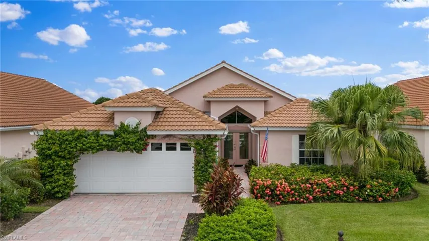 Mediterranean / spanish house featuring a garage and a front lawn