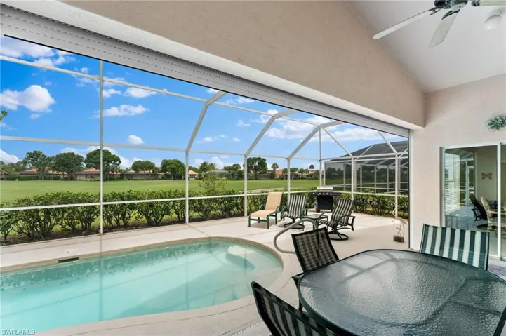 View of pool featuring a lanai, ceiling fan, and a patio area