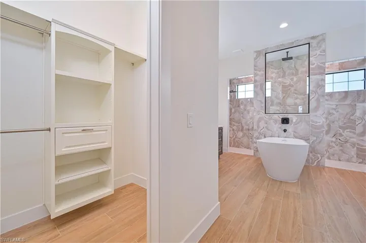 Custom closet system with built-in shelving and drawer storage
