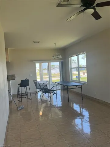 Game room featuring baseboards, a chandelier, and a ceiling fan