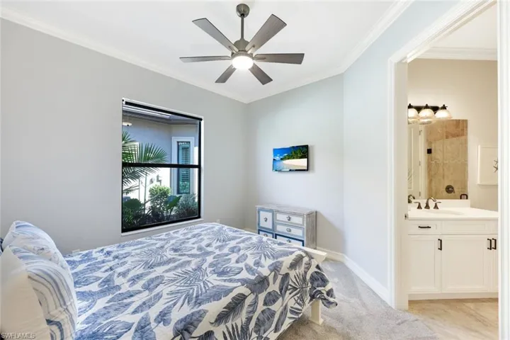 Bedroom with ensuite bath, new carpet, ceiling fan, crown molding