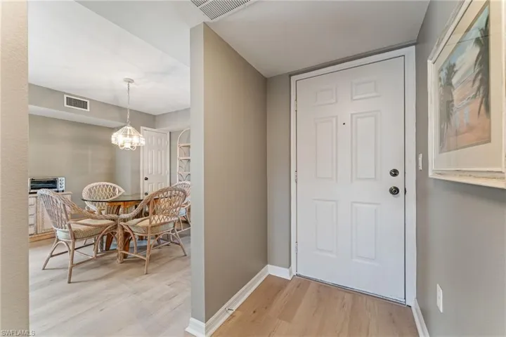Entrance foyer featuring light wood-style flooring and a chandelier