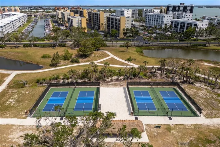 Drone / aerial view of apartment complex and a large body of water