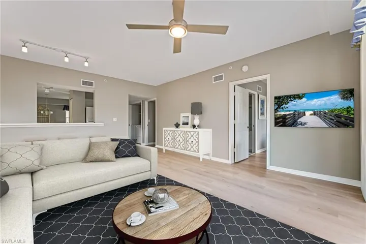 Living area with ceiling fan and light wood-style floors