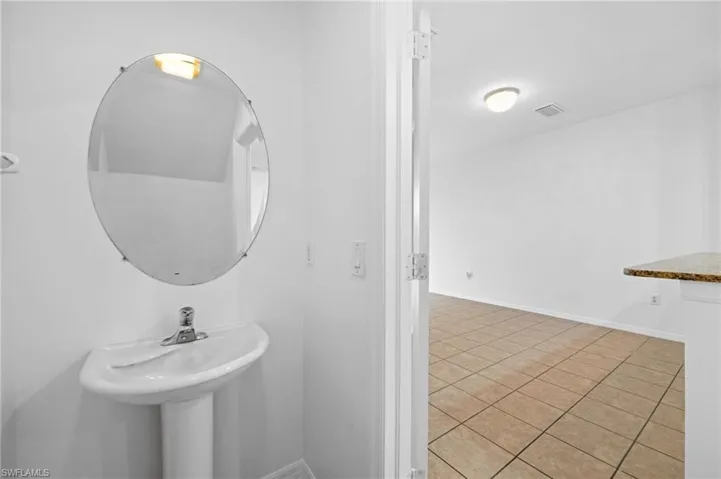 Bathroom featuring baseboards and light tile patterned floors