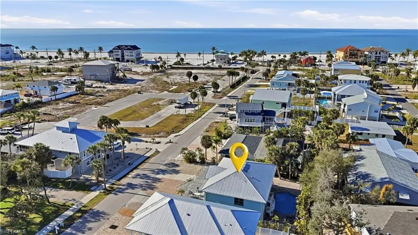 Aerial perspective of suburban area featuring a nearby body of water