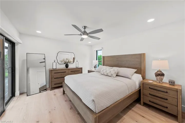 Bedroom featuring access to outside, light wood-type flooring, ceiling fan, and recessed lighting