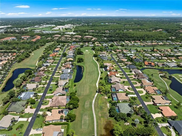 Aerial view of property's location with nearby suburban area and a golf club