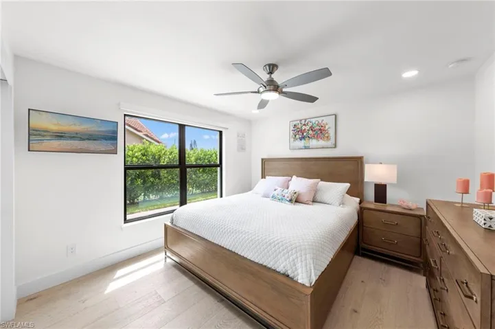 Bedroom with light wood-type flooring, a ceiling fan, and recessed lighting