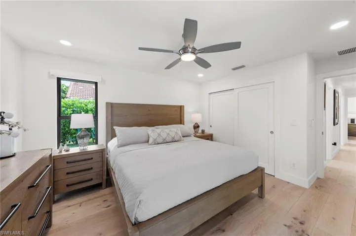 Bedroom featuring a closet, light wood-type flooring, recessed lighting, and ceiling fan