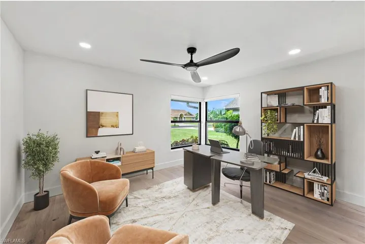 Office space with ceiling fan, recessed lighting, and light wood finished floors