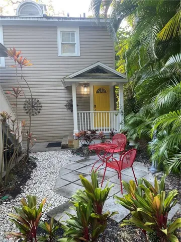 Back of property featuring covered porch