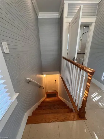 Stairway with wood walls and ornamental molding