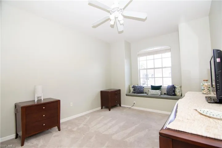 Bright and spacious second bedroom features a double closet and charming window seat.