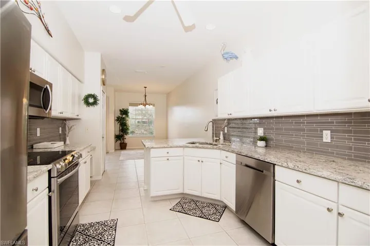 Kitchen features beautiful granite countertops and new stainless steel appliances.