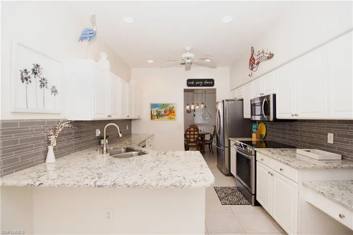 White cabinets and recessed lighting makes for a beautiful kitchen.