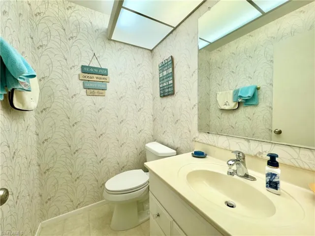 Bathroom featuring vanity, toilet, and tile patterned flooring