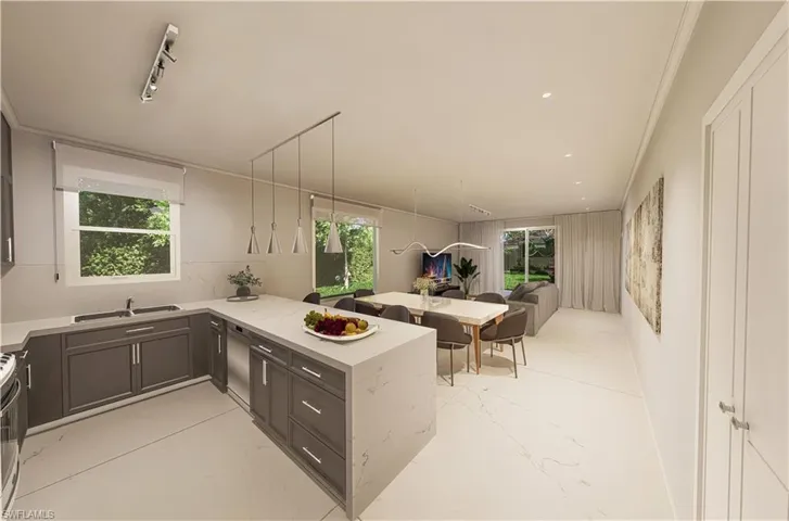 Kitchen with gray cabinetry, open floor plan, stainless steel range with electric stovetop, a peninsula, and a sink
