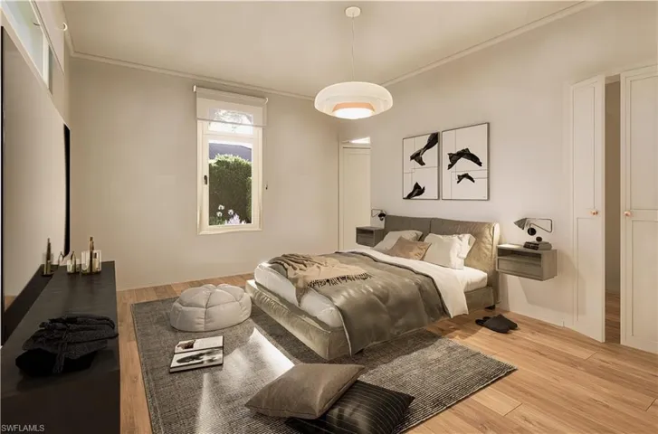 Bedroom featuring crown molding and wood finished floors