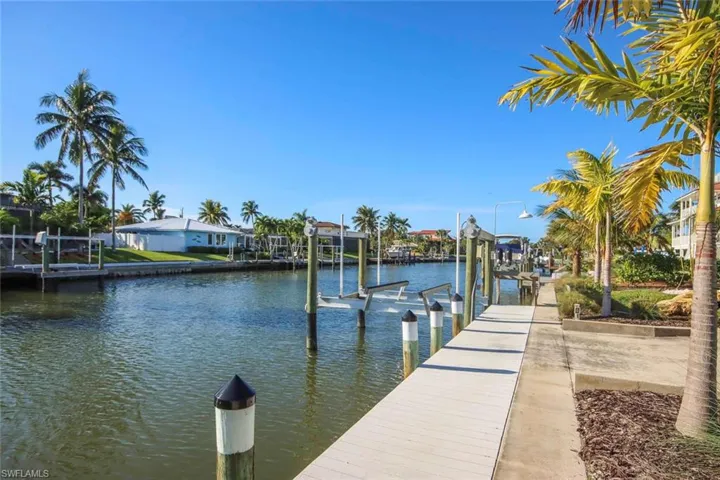 Dock with boat lift and a water view