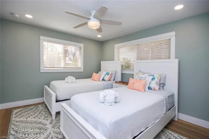 Bedroom with wood finished floors, a ceiling fan, and recessed lighting