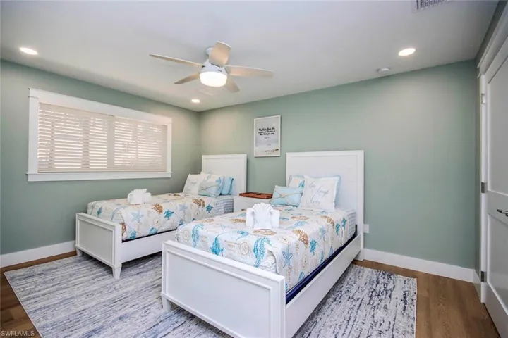 Bedroom with wood finished floors, ceiling fan, and recessed lighting