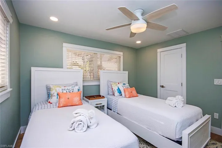 Bedroom with a ceiling fan and recessed lighting