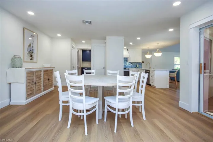 Dining space with recessed lighting and light wood finished floors