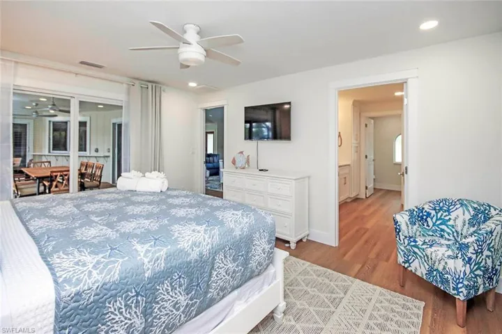 Bedroom with wood finished floors, recessed lighting, and ceiling fan