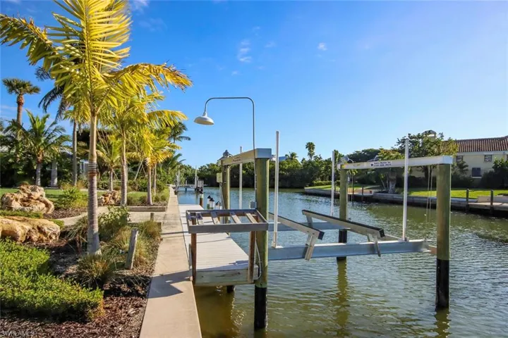 Dock area with boat lift and a water view